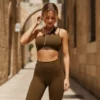 Model wearing Manual Product - Adjusting white wired headphones, looking down, natural candid movement, urban lifestyle vibe at Ancient Jerusalem stone architecture, narrow historical alleys, warm golden sunlight, authentic Middle Eastern atmosphere